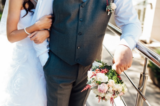 Beau bouquet de mariée entre les mains du marié