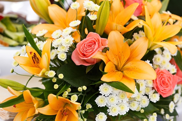 Beau bouquet de mariée de lys et de roses lors d'une fête de mariage