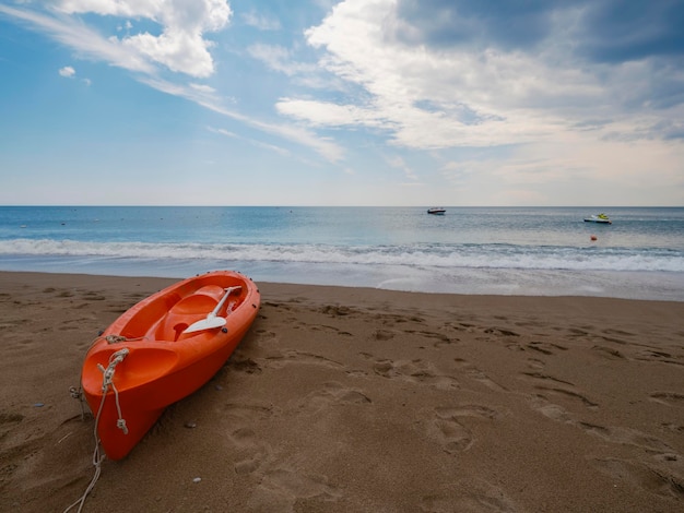 Un beau canoë rouge sur la plage