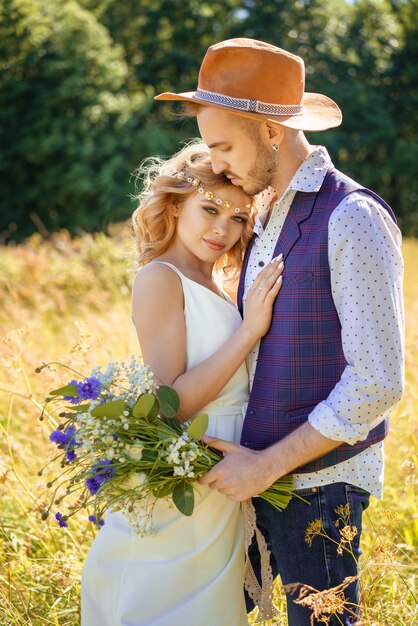 Beau couple caresses en été dans un champ