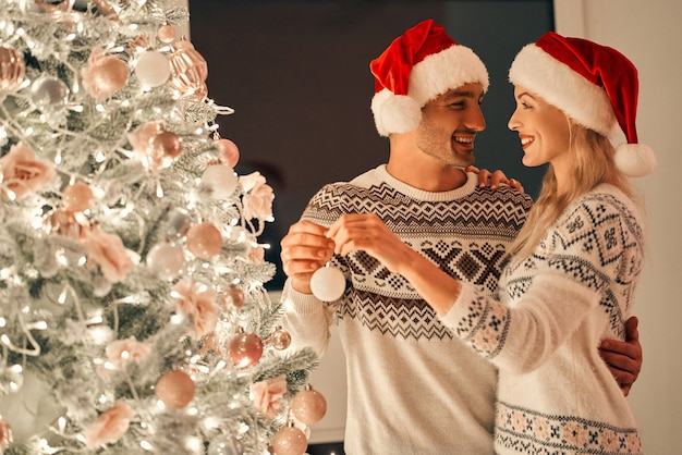 Le beau couple décorant le sapin de Noël