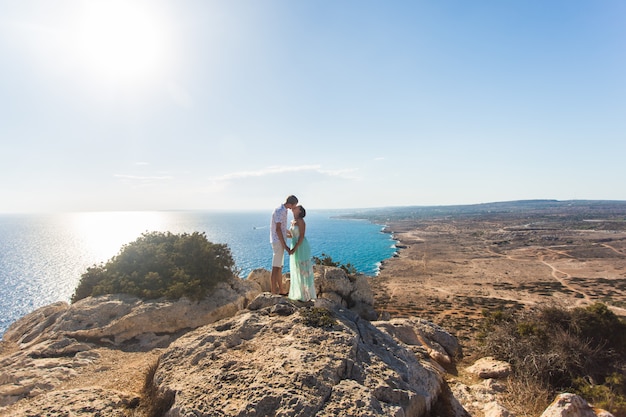 Beau couple embrasse sur une pierre et fond de la mer