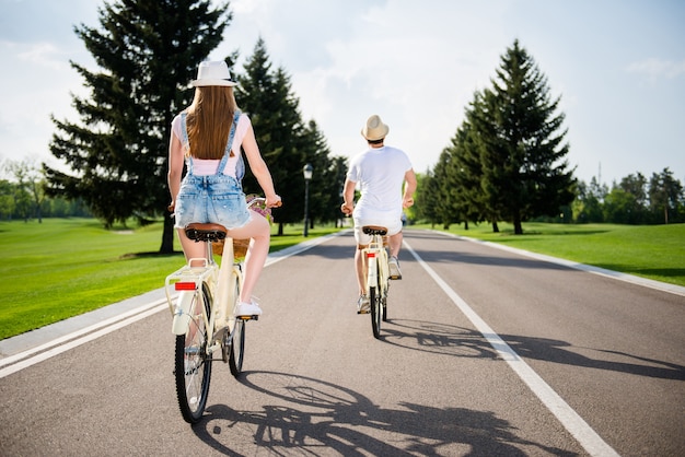 Beau couple posant ensemble à l'extérieur avec des vélos