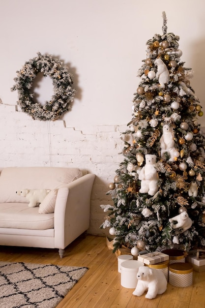 Beau grand sapin de Noël décoré de boules et de jouetscadeaux d'ambiance de Noël de vacances avec des rubansSapin de Noël décoré d'un arbre de peluches avec un intérieur ours polaire