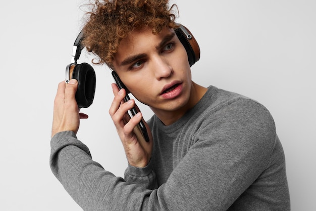 Beau jeune homme regardant le mode de vie des écouteurs de téléphone inchangé