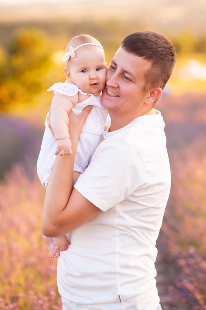 Beau jeune père avec bébé sur champ de lavande