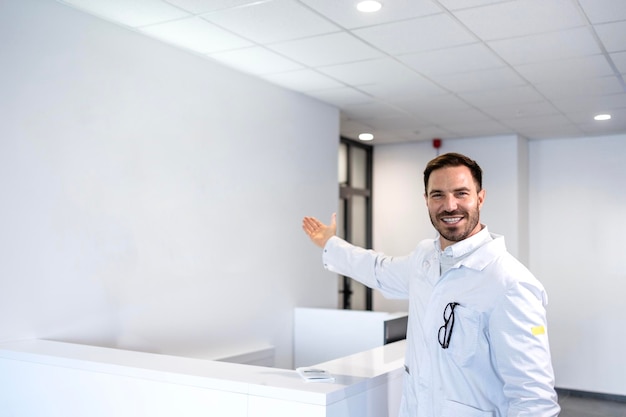 Un beau médecin caucasien accueille des patients à l'hôpital.