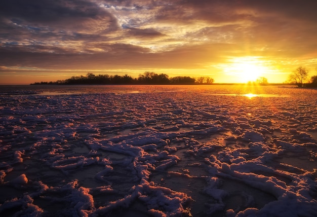 Beau paysage d'hiver avec ciel coucher de soleil et lac gelé. Composition de la nature.