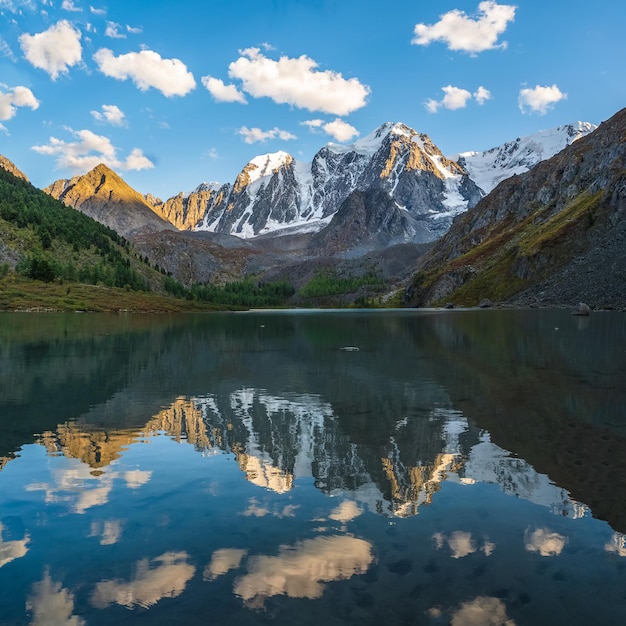 Beau paysage de soirée avec reflet de glacier dans la surface de l'eau du lac de montagne Montagne enneigée reflétée dans l'eau claire du lac glaciaire Neige sur la roche reflétée dans le lac de montagne