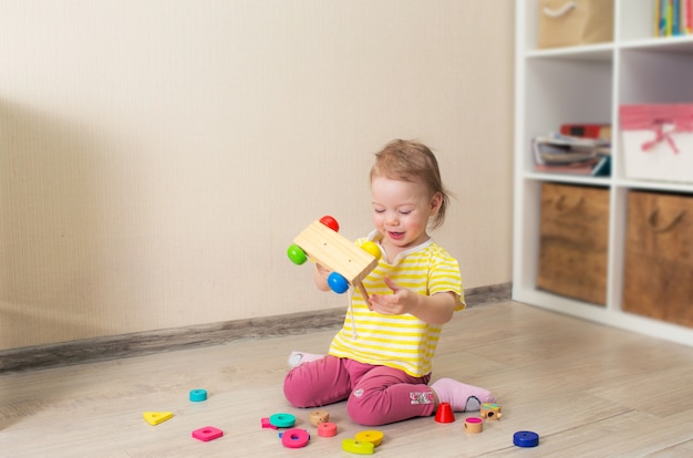 Beau petit enfant joue avec des cubes en bois