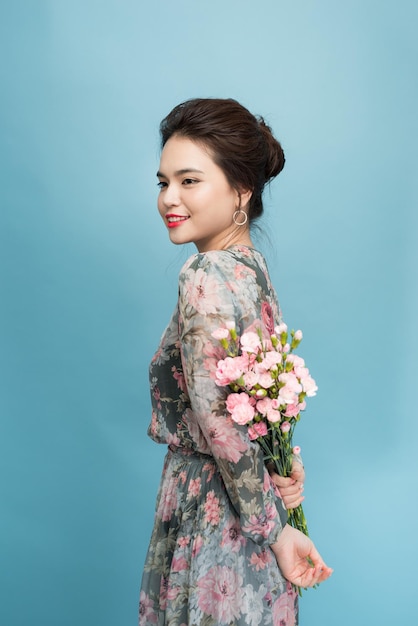 Beau portrait de jolie femme avec bouquet de fleurs, maquillage de mode, robe élégante