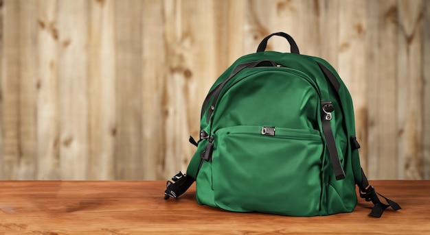 Photo beau sac vert sur une table en bois avec un bon éclairage en haute définition