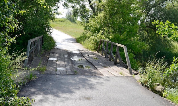 Beau vieux pont en bois au-dessus de la rivière dans un arrière-plan coloré photographie en gros plan composée d'un vieux pont en bois au-dessus de la rivière dans le feuillage vieux pont en bois à la rivière pour le parc naturel sauvage