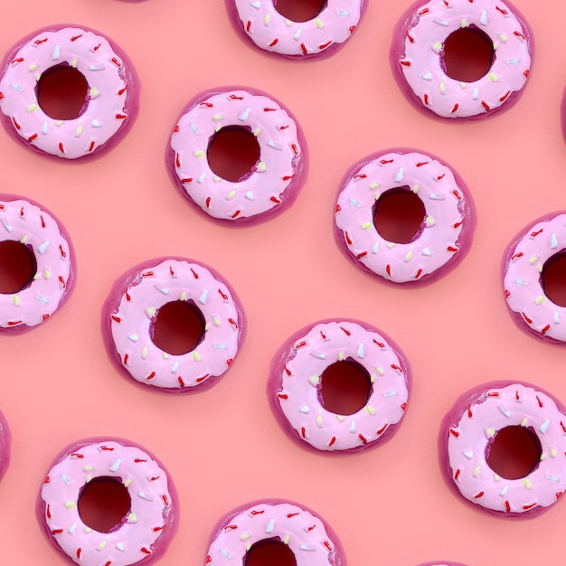 Beaucoup de petits beignets en plastique se trouvent sur un fond coloré pastel