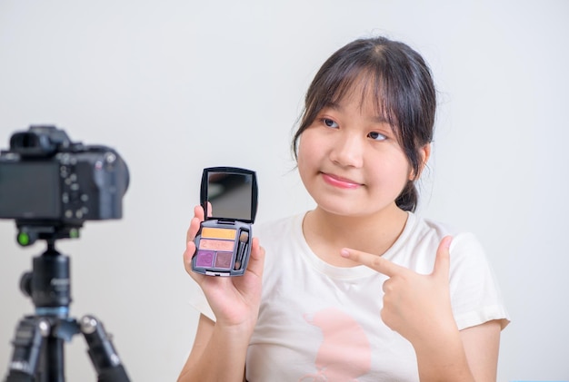 Beauté fille blogueuse concept femme asiatique utiliser un pinceau pour appliquer le fard à paupières