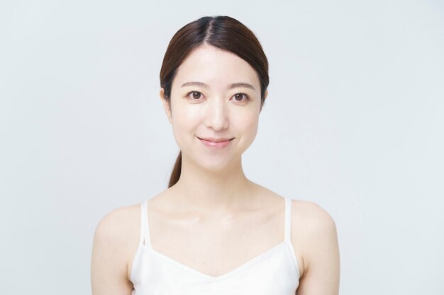 Beauté / image de soins de la peau / femme souriante portant une camisole blanche