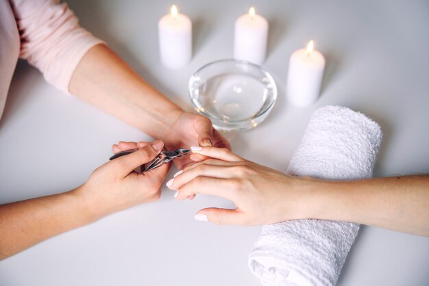 Beauté des ongles. Mains de femme recevant un traitement de soin des ongles par un spécialiste professionnel de la manucure dans un salon de manucure.