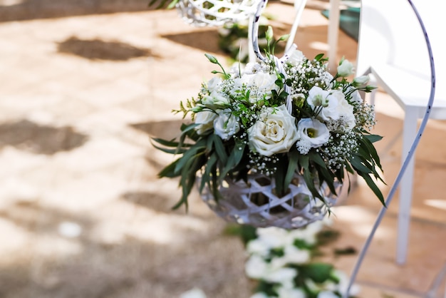 Beaux arrangements floraux de mariage le long de l'allée