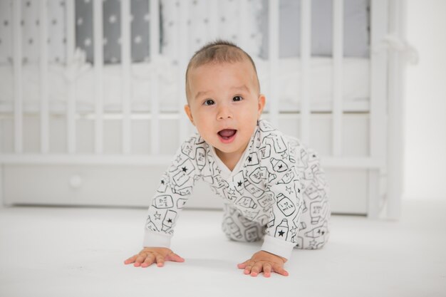 bébé dans un lit de bébé sur un fond clair