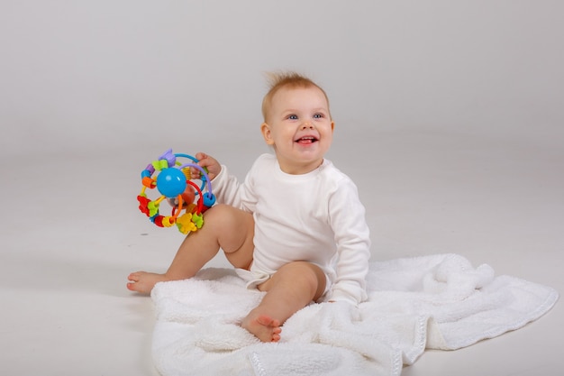 Bébé jouant jouet coloré isolé sur fond blanc