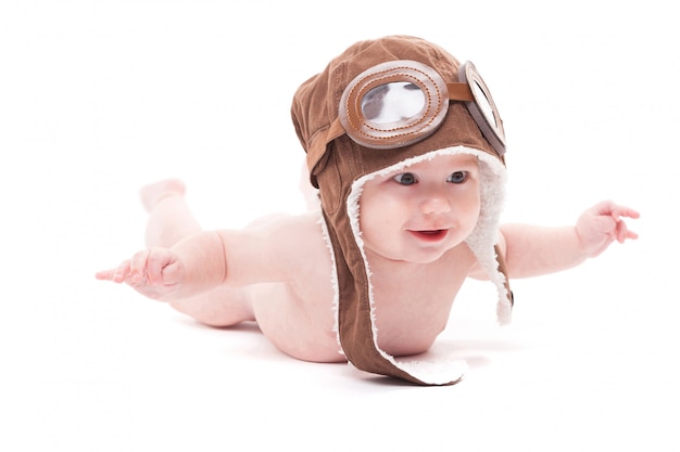 Bébé souriant mignon nue dans la casquette du pilote vole aw