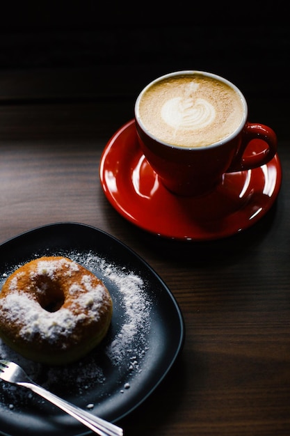 Un beignet et une tasse de café chaud