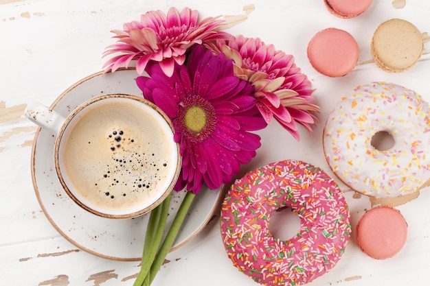 Beignets de tasse à café et fleurs de gerbera