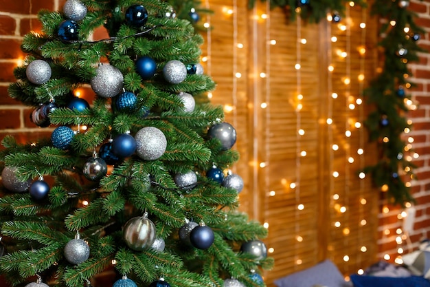 Bel arbre de Noël décoré de jouets bleus et argentés