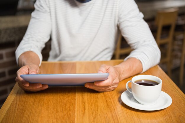 Bel homme à l'aide d'une tablette