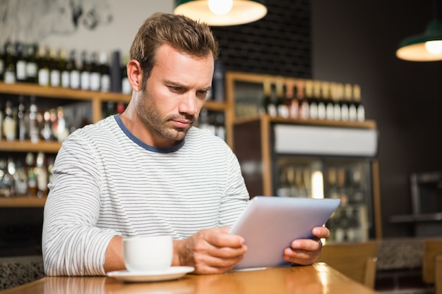 Bel homme à l'aide d'une tablette