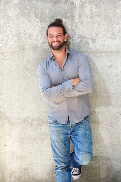 Bel homme souriant avec les bras croisés