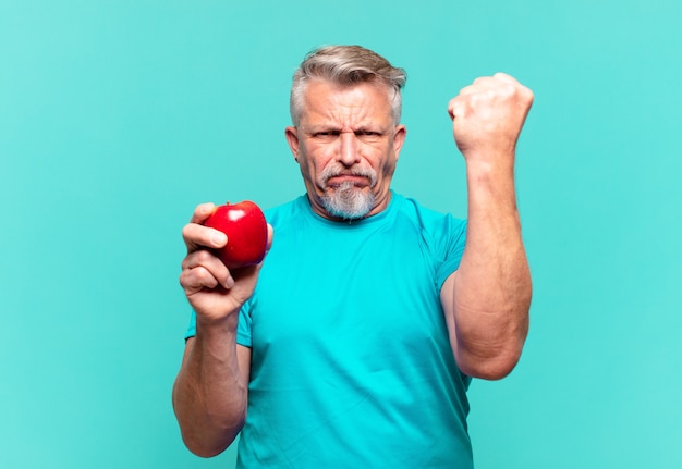 Bel homme supérieur avec une pomme