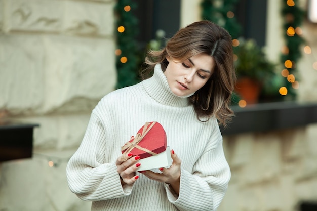 La belle brune reçoit un cadeau pour le réveillon ou la Saint-Valentin