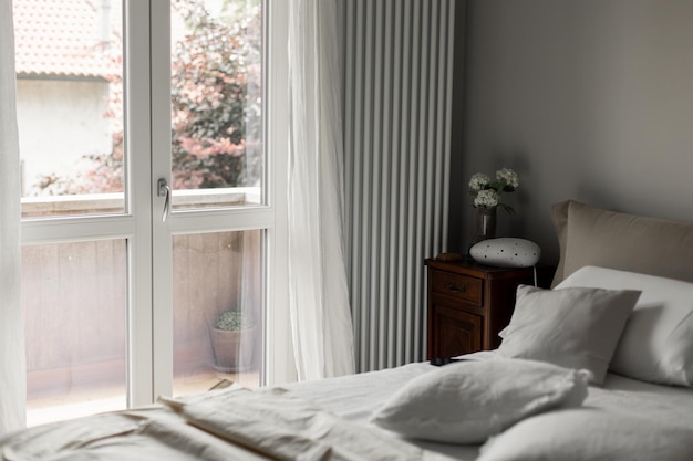 Belle chambre d'hôtel avec un lit d'oreiller et une grande fenêtre