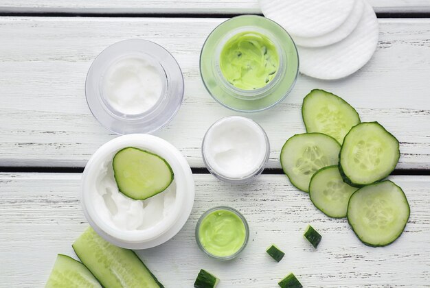 Belle composition avec des tranches de concombre et des ingrédients pour masque sur table