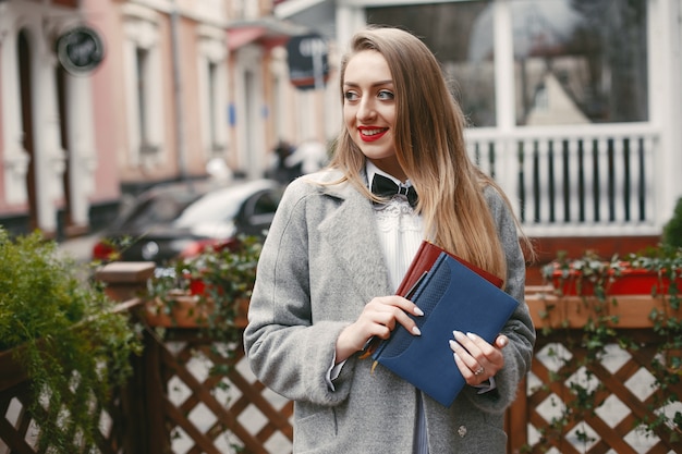 belle et élégante jeune femme d&#39;affaires se tient dans une ville d&#39;été près du bâtiment