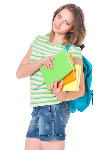 Une belle étudiante avec un sac à dos et des livres isolés sur un fond blanc