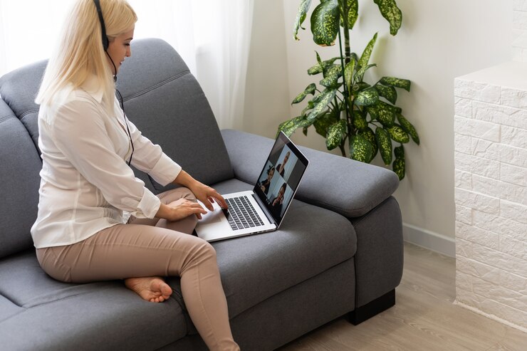 Photo belle étudiante souriante utilisant le service d'éducation en ligne. jeune femme regardant dans un écran d'ordinateur portable en regardant un cours de formation et en l'écoutant avec des écouteurs. concept de technologie d'étude moderne