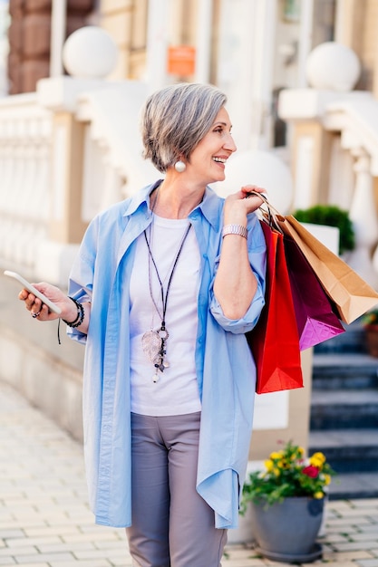 Belle femme âgée faisant du shopping dans un magasin de vêtements