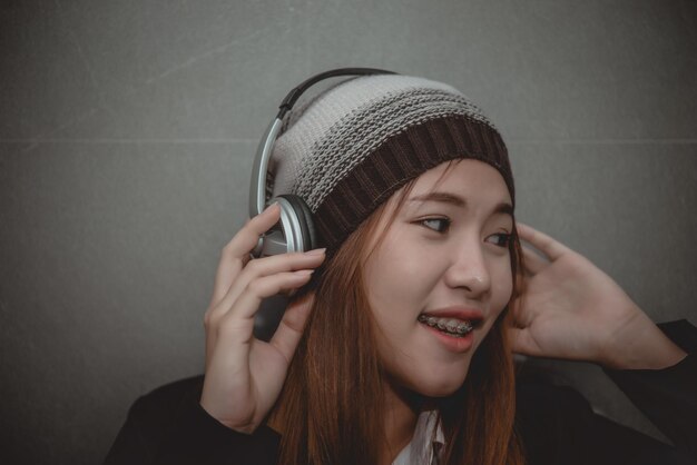 Belle femme asiatique écoute de la musique avec un casque