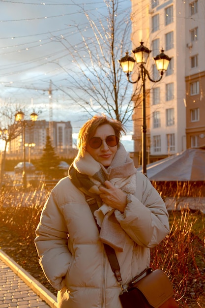 Belle femme baby-boomer d'âge moyen dans des lunettes de soleil et des vêtements décontractés élégants dans la rue aga ...