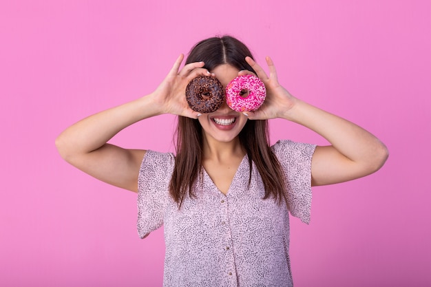 Belle femme avec des beignets sur les yeux