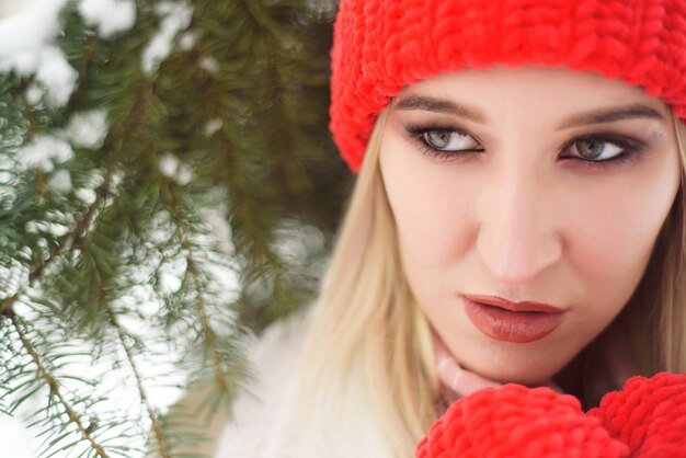 Belle femme avec un chapeau rouge en hiver