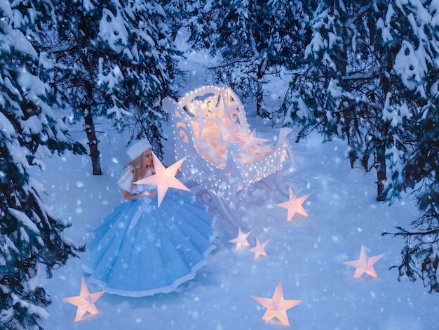 Photo belle femme comme fille des neiges avec traîneau et étoiles