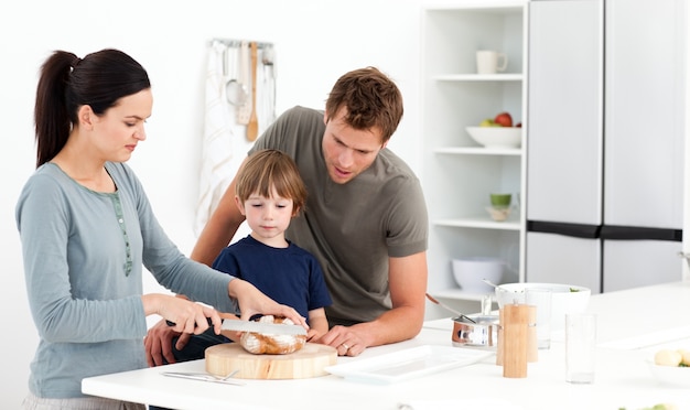 Belle femme coupe du pain pour son fils ad mari