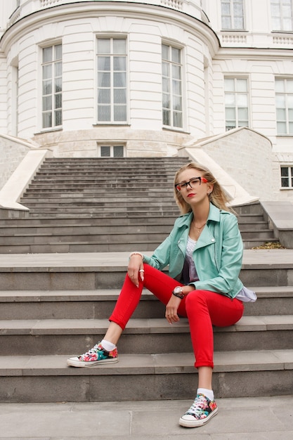 Belle femme élégante assise sur les escaliers