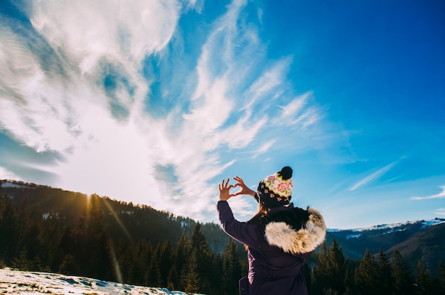 Belle femme élégante dans les montagnes enneigées, jolie fille de haute montagne couverte de neige, concept de vacances d&#39;hiver