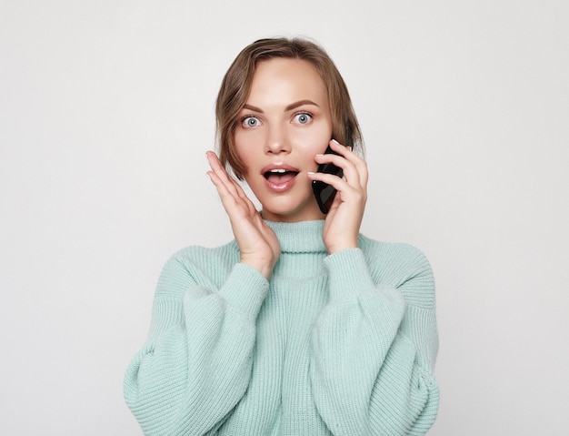 Belle femme gaie parlant au téléphone portable