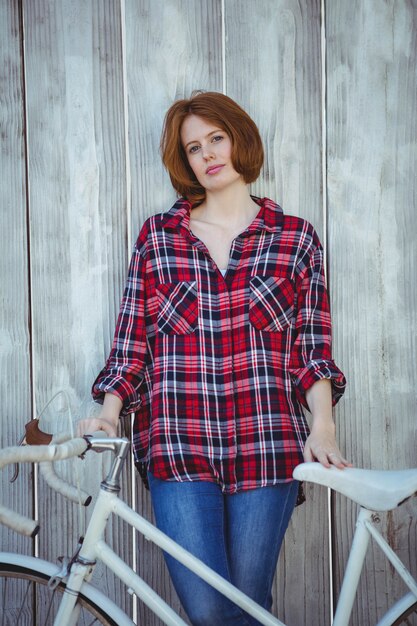 belle femme hipster avec un vélo, debout