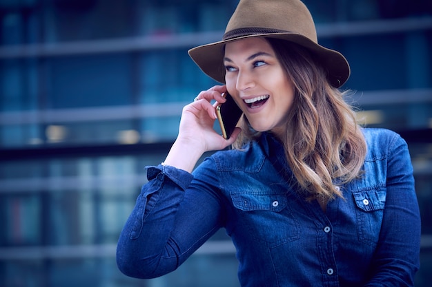 Belle femme parlant au mobile en milieu urbain